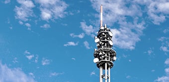 image of telecommunications tower against blue sky