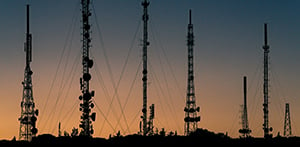 image of telecommunications towers at sunset